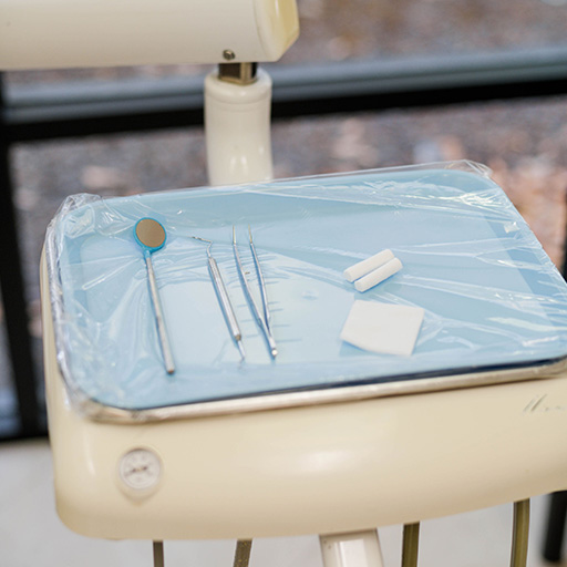 A set of sanitized dental tools on a tray