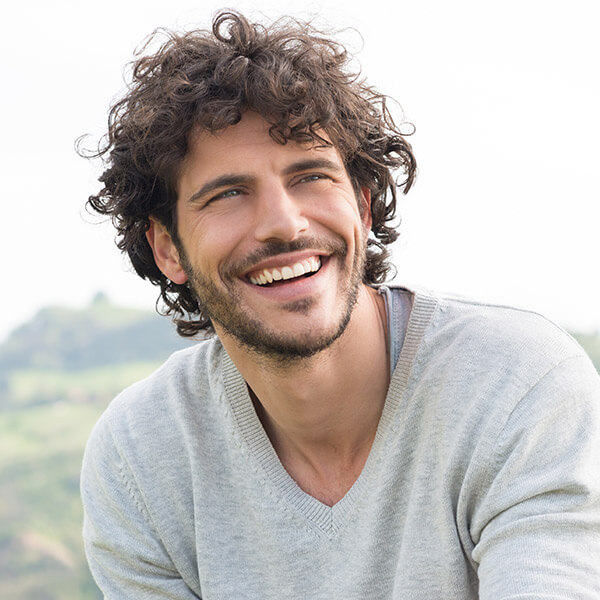 Man smiling after teeth whitening procedure