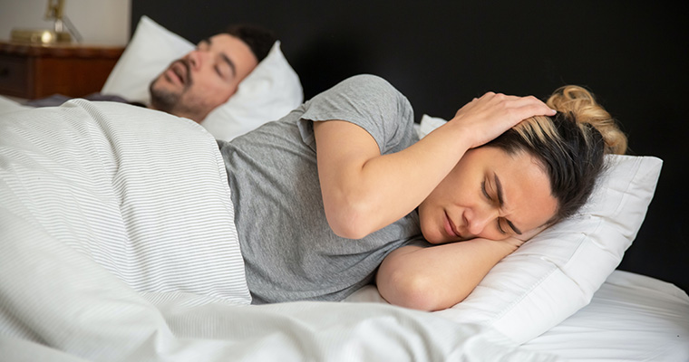 Women struggling to sleep because of not reducing snoring